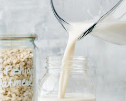 Glass jar with milk being placed in a warm place